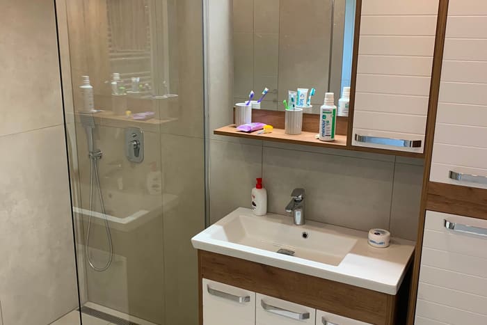 Fertig saniertes Badezimmer mit Dusche, Waschtisch und Spiegelschrank